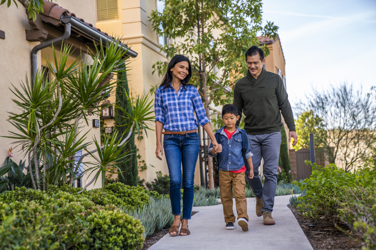 Family with kid walking to school