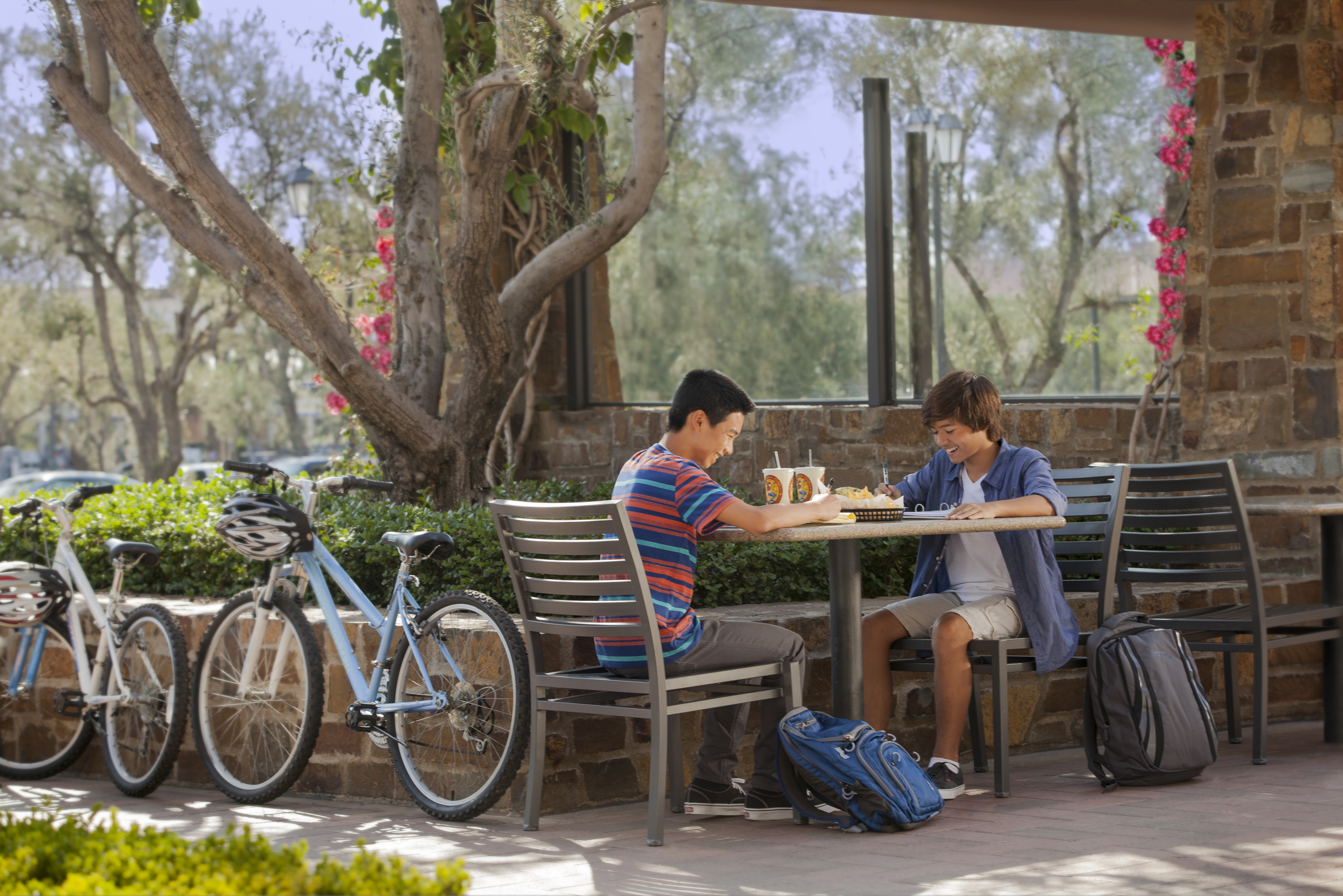 Boys with backpacks at lunch table